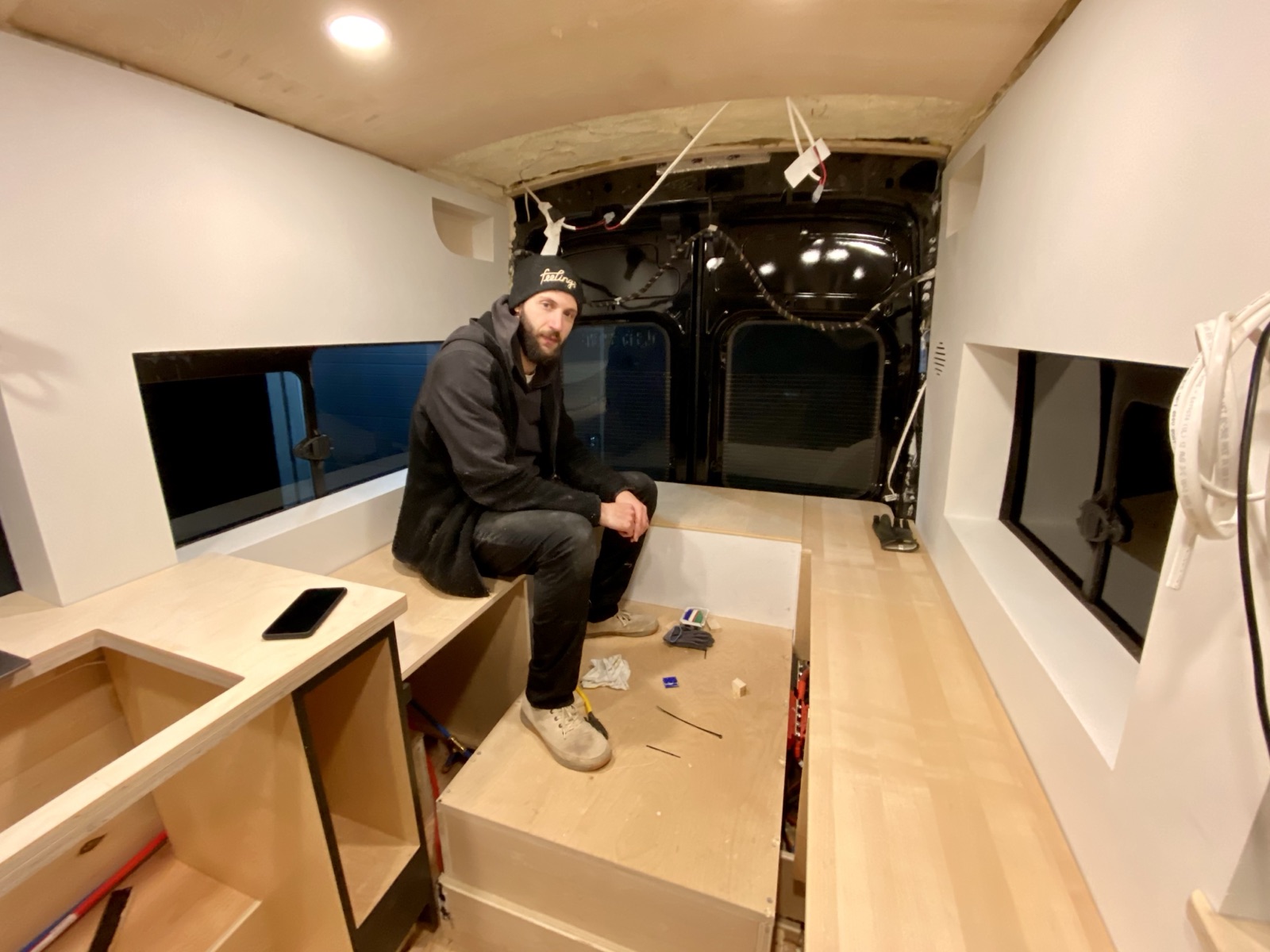 Mark sitting on the rear platform inside the van