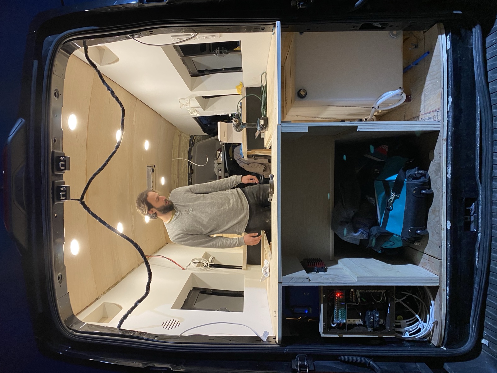 Mark working at the counter, seen through the open rear doors