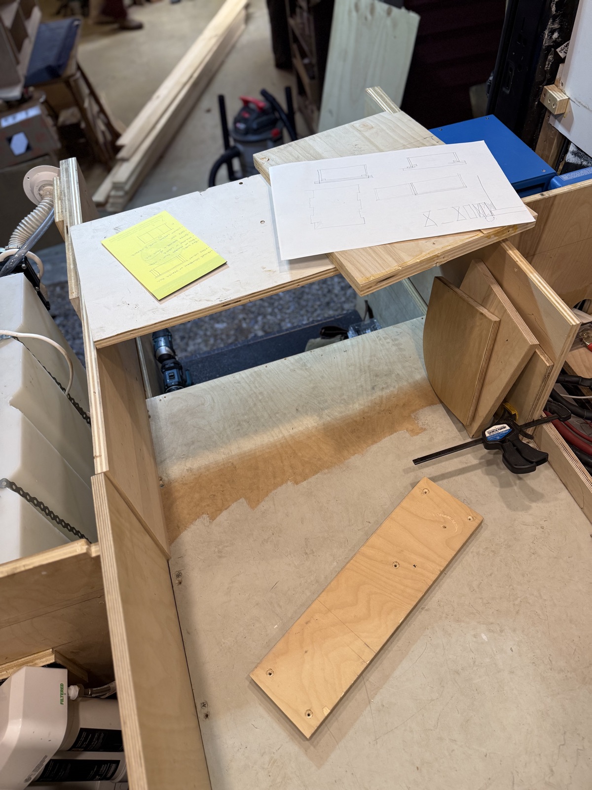 The new plywood bed platform taking shape inside the van