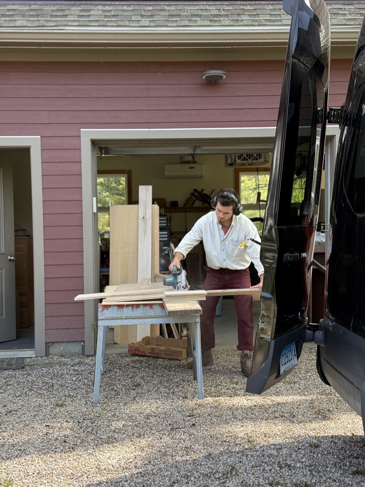 Carpentry on sawhorses beside the van