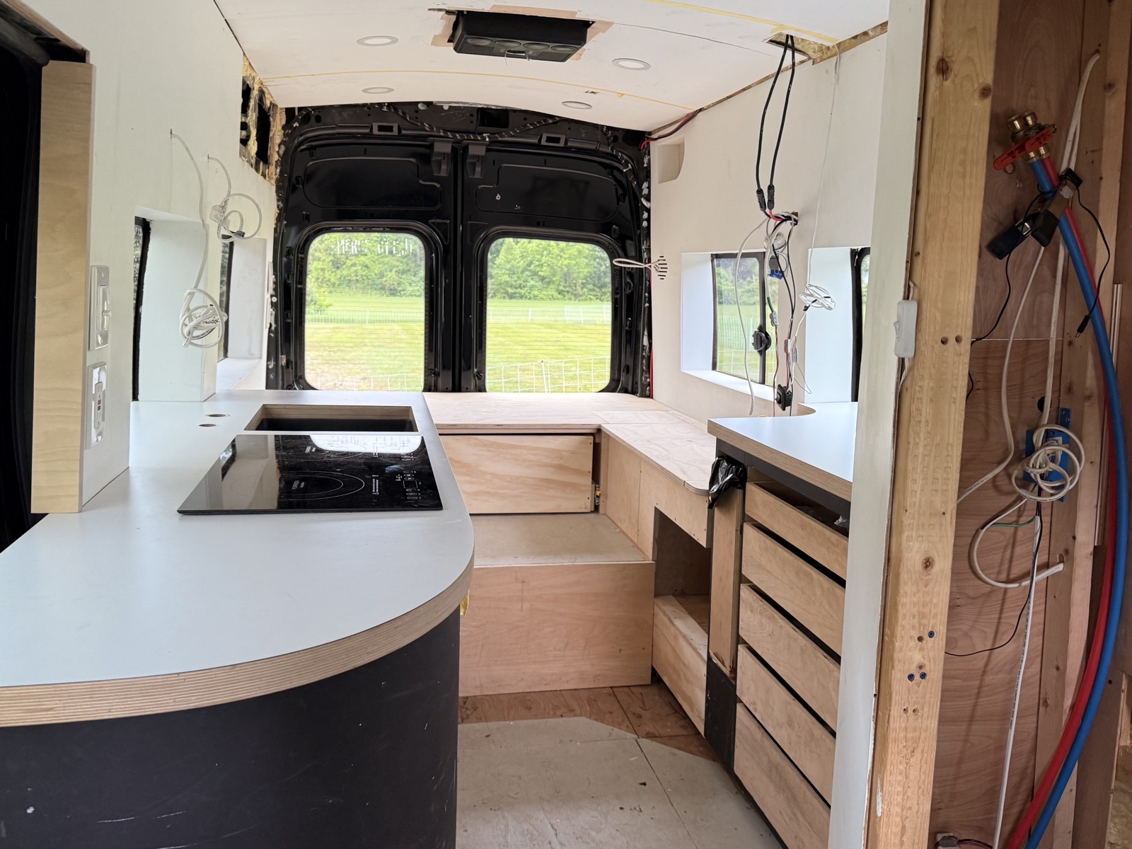 The matte black curved kitchen cabinet with white countertop