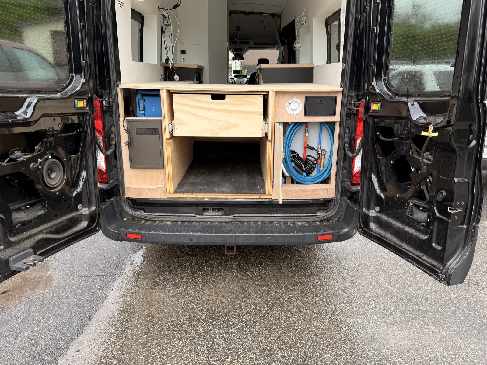 Benji from behind with rear doors open, showing storage and hose compartment